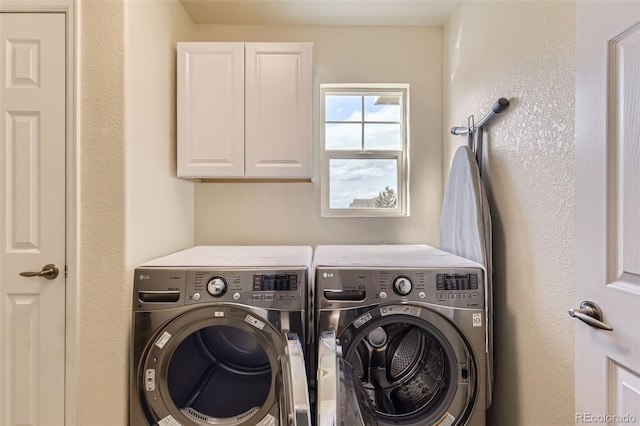 laundry area featuring cabinet space and washer and clothes dryer