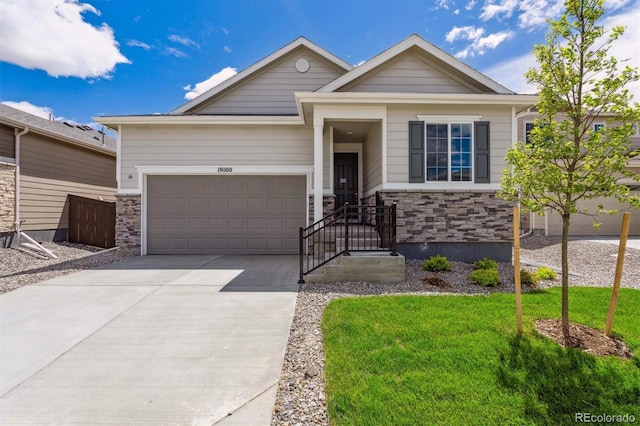 19100 E 96th Pl, Commerce City, CO 80022 - ranch-style home with an attached garage, concrete driveway, a front yard, and stone siding