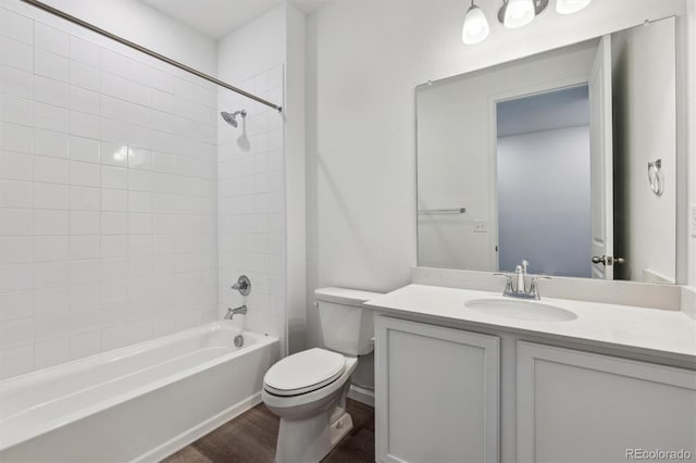 19100 E 96th Pl, Commerce City, CO 80022 - bathroom featuring toilet, vanity, washtub / shower combination, and wood finished floors