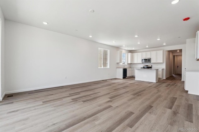 19100 E 96th Pl, Commerce City, CO 80022 - unfurnished living room featuring recessed lighting, light wood finished floors, and baseboards