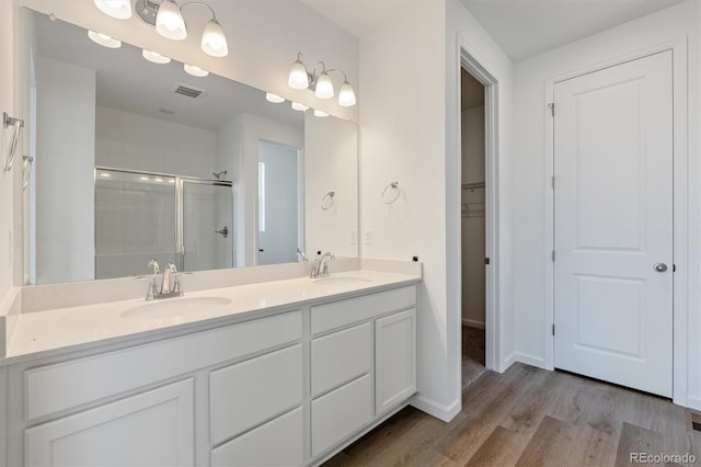 19100 E 96th Pl, Commerce City, CO 80022 - full bathroom featuring a stall shower, wood finished floors, and double vanity