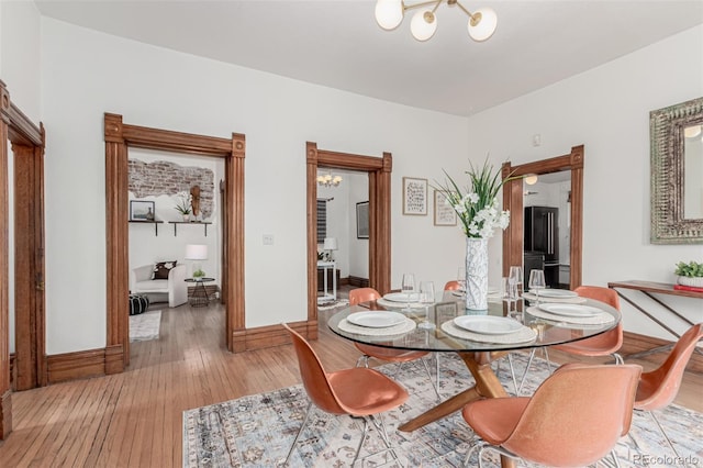 2719 W 32nd Ave, Denver, CO 80211 - dining space featuring light wood-style flooring and a chandelier