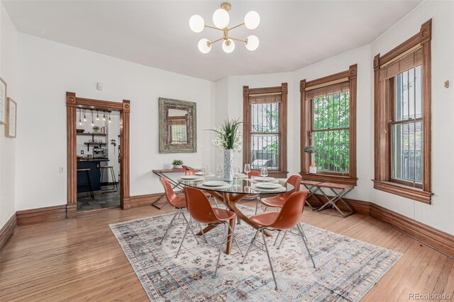 2719 W 32nd Ave, Denver, CO 80211 - dining space with a chandelier, plenty of natural light, and light wood-style flooring