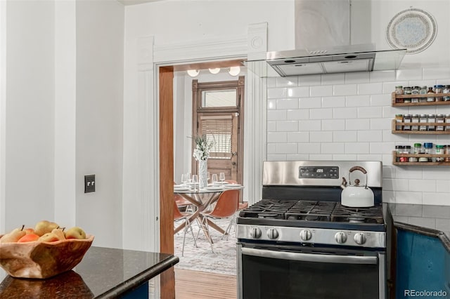 2719 W 32nd Ave, Denver, CO 80211 - kitchen with stainless steel gas stove, ventilation hood, wood finished floors, backsplash, and open shelves