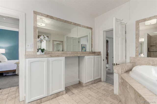 2719 W 32nd Ave, Denver, CO 80211 - ensuite bathroom with a textured ceiling, a bath, and vanity