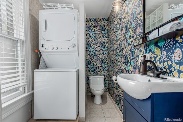 2719 W 32nd Ave, Denver, CO 80211 - bathroom featuring estacked washer and dryer, wallpapered walls, tile patterned flooring, and vanity