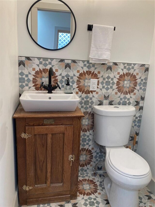 2719 W 32nd Ave, Denver, CO 80211 - bathroom with vanity, tile walls, and wainscoting