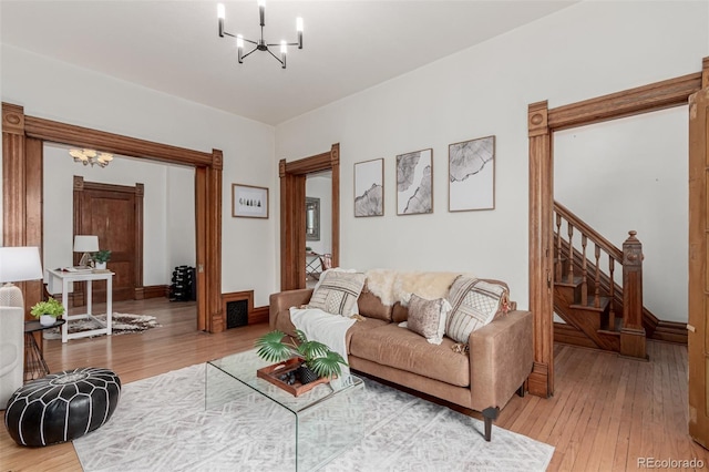 2719 W 32nd Ave, Denver, CO 80211 - living room featuring a chandelier, light wood-style floors, and stairway
