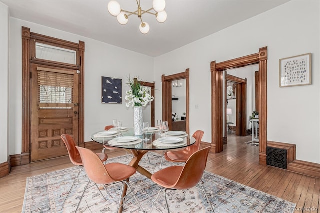 2719 W 32nd Ave, Denver, CO 80211 - dining area featuring light wood-style floors and a chandelier