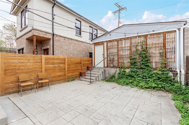2719 W 32nd Ave, Denver, CO 80211 - rear view of house with brick siding, a patio area, and entry steps