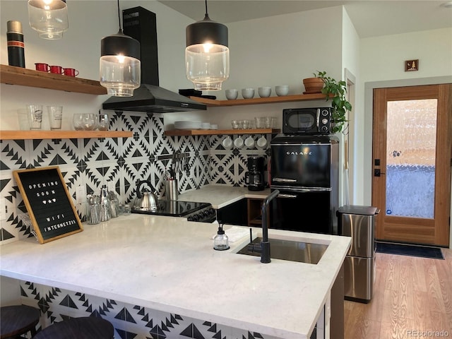 2719 W 32nd Ave, Denver, CO 80211 - kitchen with extractor fan, open shelves, black microwave, light wood-style flooring, and tasteful backsplash