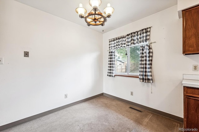 unfurnished dining area featuring light carpet and an inviting chandelier