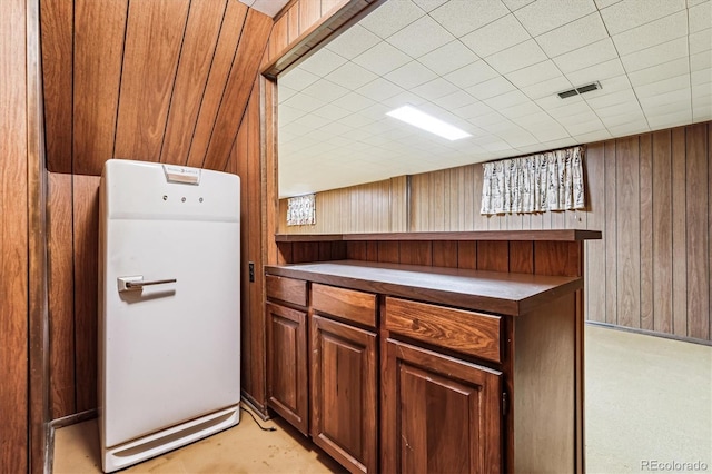 kitchen featuring wooden walls