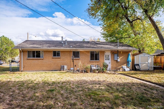 back of property featuring a yard and a shed