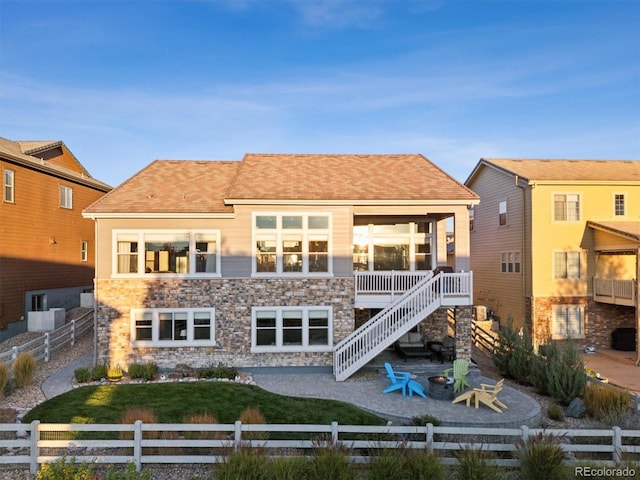 rear view of house featuring a fire pit