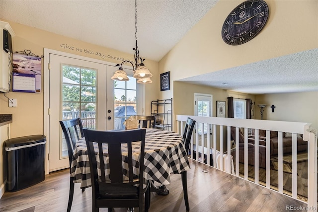 2251 W 135th Pl, Denver, CO 80234 - dining area with a textured ceiling, vaulted ceiling, and wood finished floors