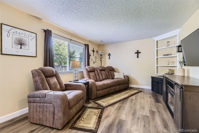 2251 W 135th Pl, Denver, CO 80234 - living room with light wood-style flooring and a textured ceiling