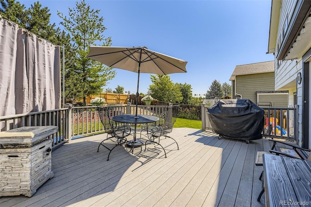 2251 W 135th Pl, Denver, CO 80234 - wooden terrace featuring outdoor dining space, a fenced backyard, and a grill