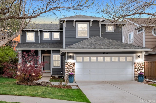 traditional-style home with an attached garage, a shingled roof, stone siding, and concrete driveway