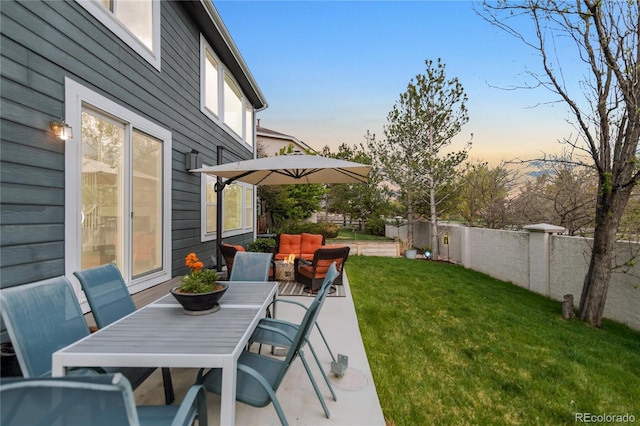 view of patio / terrace featuring a fenced backyard, outdoor dining space, and an outdoor hangout area