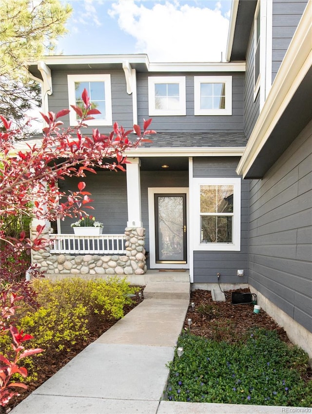 view of exterior entry with a porch