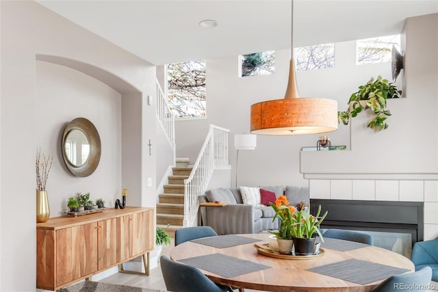 dining area featuring stairway and a towering ceiling