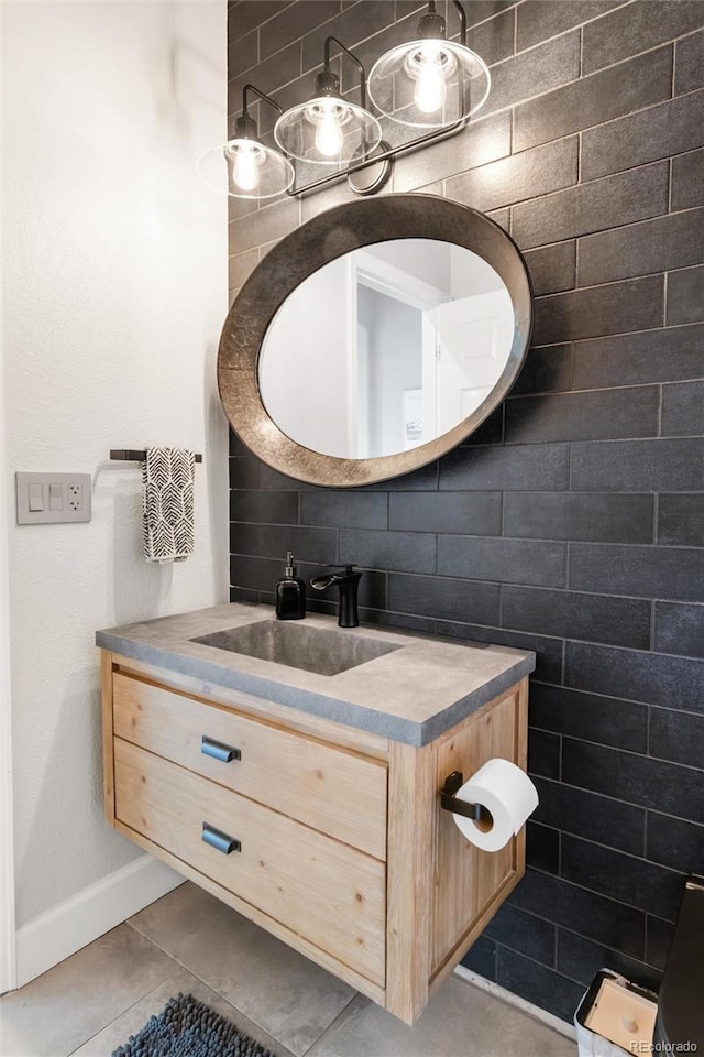 bathroom with vanity, baseboards, backsplash, and tile patterned floors
