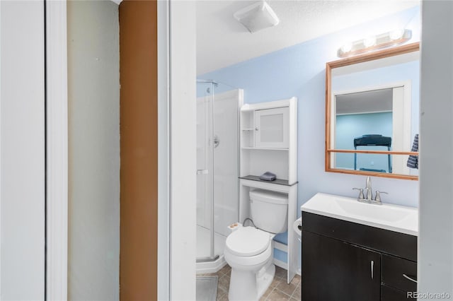 full bath featuring toilet, tile patterned floors, a shower stall, and vanity