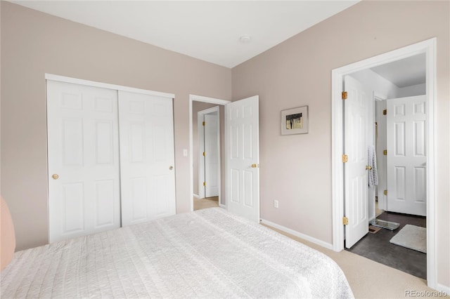 carpeted bedroom with baseboards and a closet
