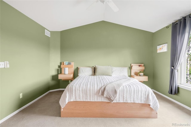 carpeted bedroom featuring a ceiling fan, baseboards, visible vents, and lofted ceiling