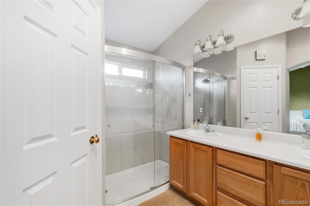 full bath with vanity, a shower stall, and ensuite bath