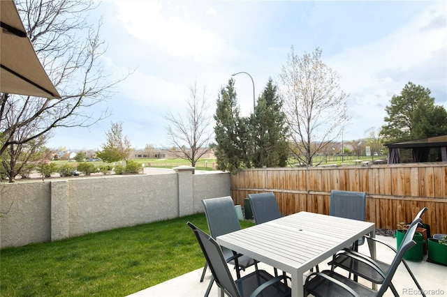 view of patio / terrace featuring fence and outdoor dining space