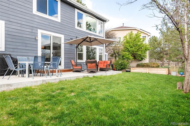 back of house featuring a lawn, an outdoor living space, and a patio area