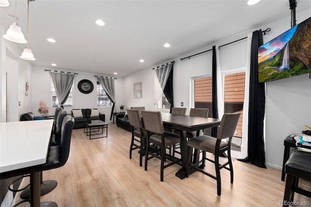 dining space with light hardwood / wood-style floors