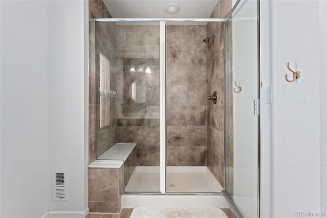 bathroom with a shower with shower door