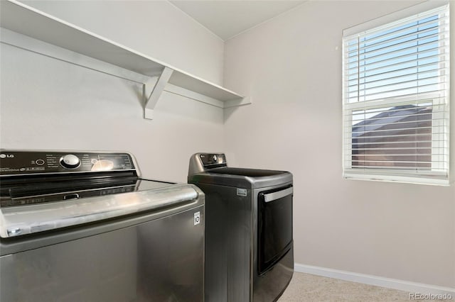 clothes washing area featuring independent washer and dryer