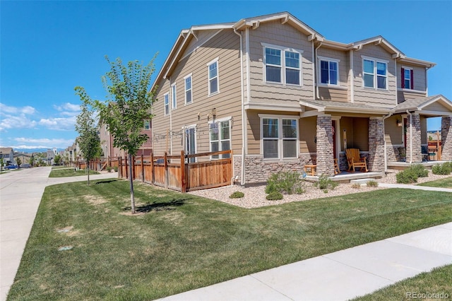 4316 S Netherland St, Aurora, CO 80015 - view of front of house with stone siding, a porch, and a front yard
