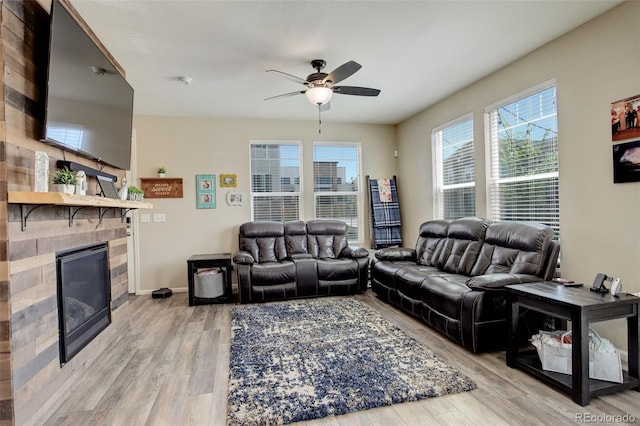 4316 S Netherland St, Aurora, CO 80015 - living area featuring a ceiling fan, a glass covered fireplace, light wood finished floors, and baseboards
