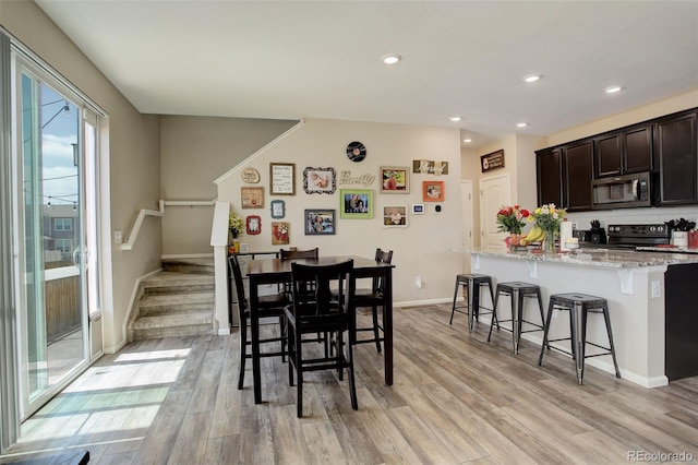 4316 S Netherland St, Aurora, CO 80015 - dining room with light wood finished floors, stairs, recessed lighting, and baseboards
