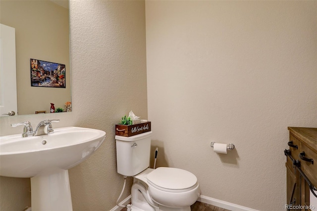 4316 S Netherland St, Aurora, CO 80015 - bathroom featuring toilet, baseboards, a sink, and wood finished floors