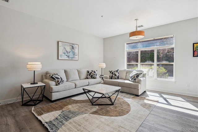 living area featuring wood finished floors and baseboards