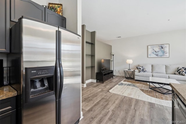 living room featuring light wood finished floors and baseboards