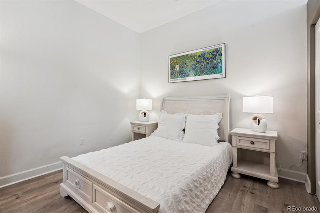 bedroom featuring wood finished floors and baseboards