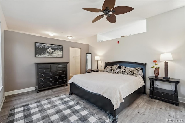 bedroom with wood finished floors, baseboards, and ceiling fan