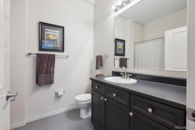 full bathroom featuring toilet, baseboards, vanity, and tile patterned flooring