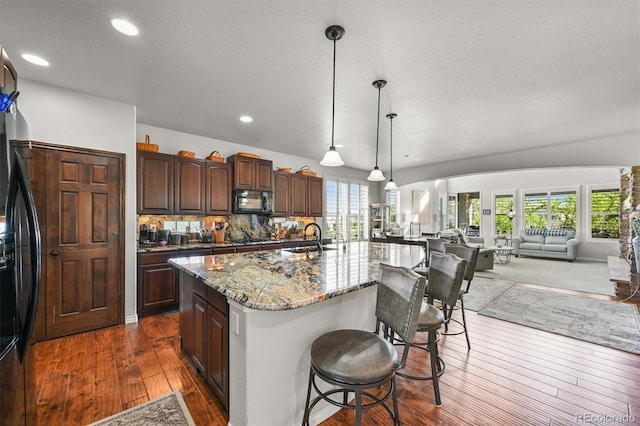 2373 S Joyce St, Denver, CO 80228 - kitchen featuring a sink, dark wood finished floors, healthy amount of natural light, black appliances, and recessed lighting