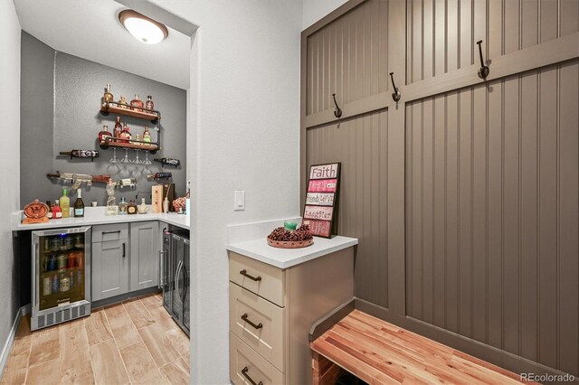 2373 S Joyce St, Denver, CO 80228 - indoor dry bar featuring beverage cooler and light wood finished floors
