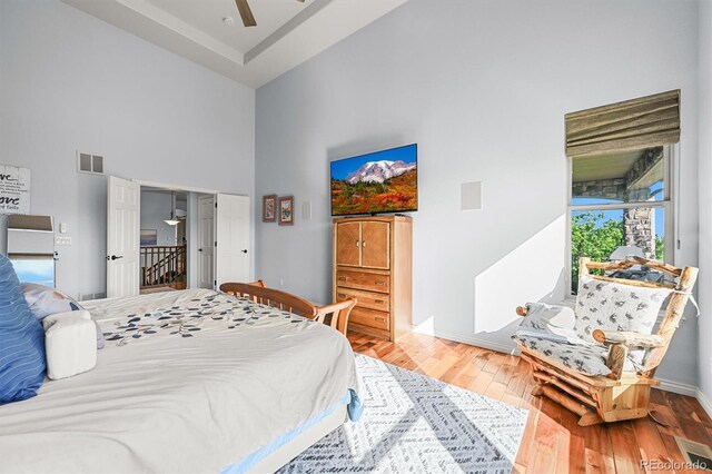 2373 S Joyce St, Denver, CO 80228 - bedroom featuring a towering ceiling, wood finished floors, baseboards, and a ceiling fan