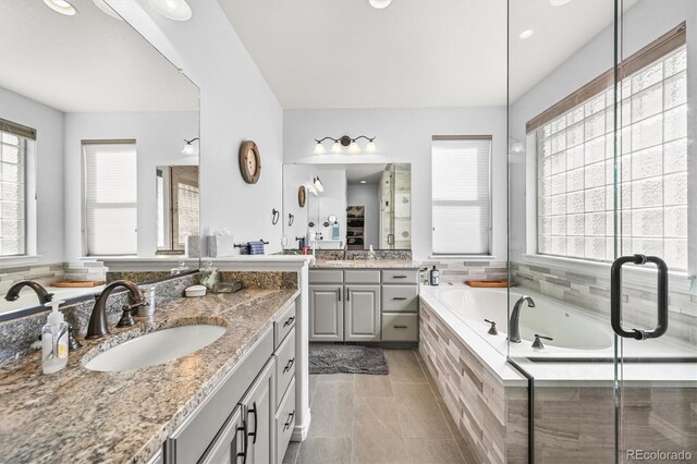 2373 S Joyce St, Denver, CO 80228 - full bath with a garden tub, two vanities, and tile patterned flooring