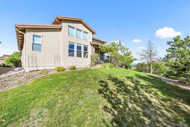 2373 S Joyce St, Denver, CO 80228 - rear view of house with stucco siding and a tiled roof